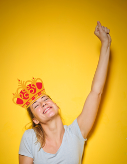 Photo of happy person with crown on head.