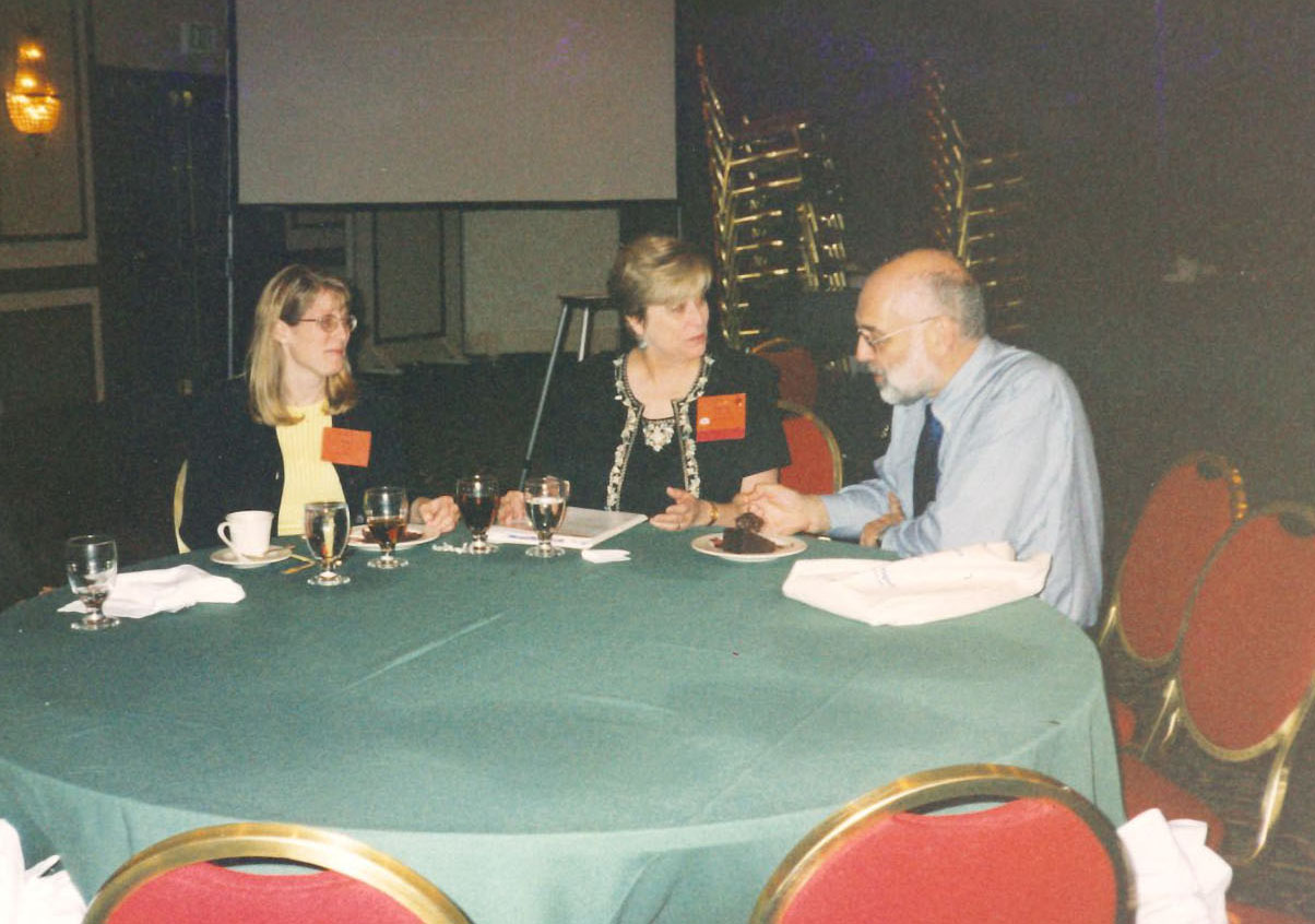 Marty Townsend (center) and Richard Bates (right) seated at a table with an unidentified woman